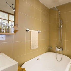 Compact 16-inch towel bar installed above toilet or beside shower.