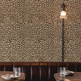 Leopard wallpaper enhances room ambiance with vibrant, energetic decor.