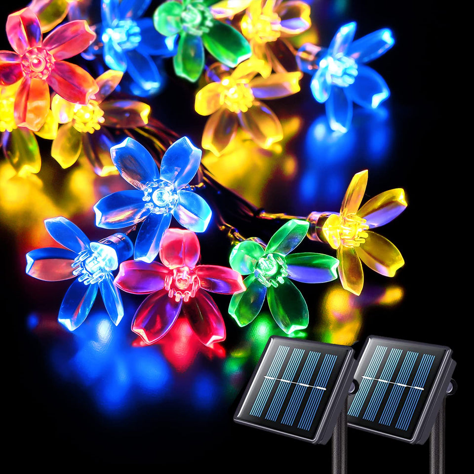 JMEXSUSS solar flower string lights illuminate cherry blossoms in purple for festive outdoor nights.