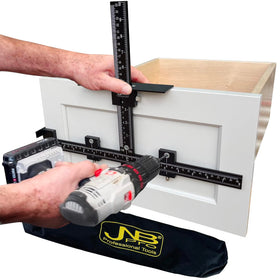 JNB Pro center drill guide demonstrates precise hole alignment for drawer handles.
