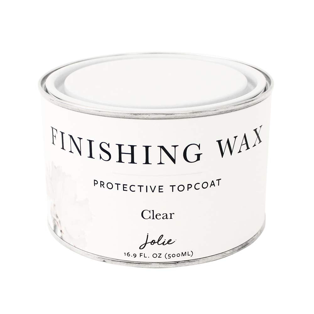 Jolie Finishing Wax clear bottle closeup showing odor-free protection for furniture.
