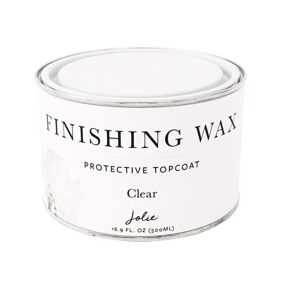 Jolie Finishing Wax clear bottle closeup showing odor-free protection for furniture.