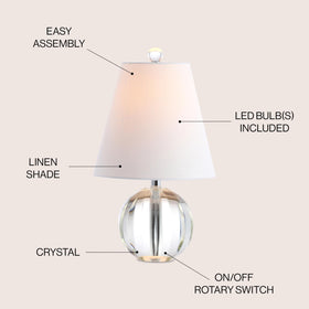 JONATHAN Y bedside lamp on a nightstand offers warm task lighting.