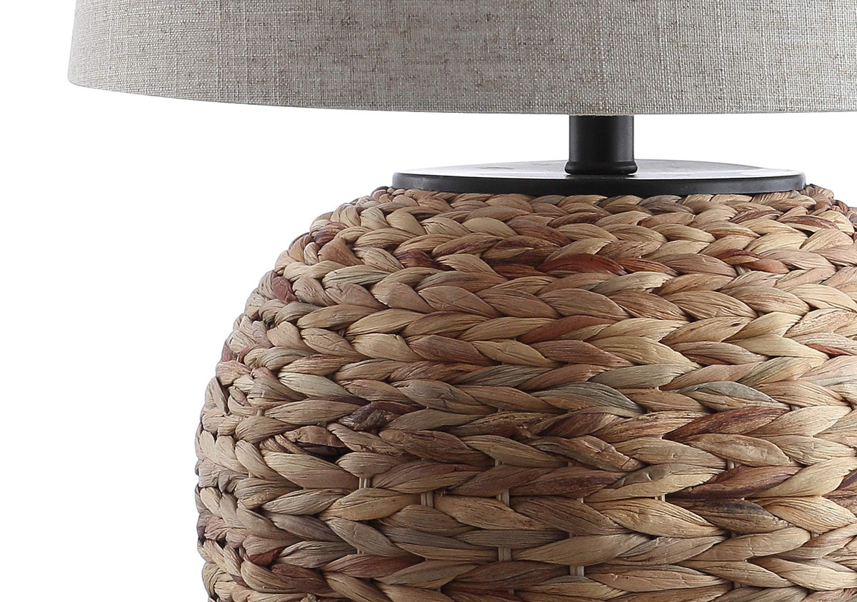 JONATHAN Y lamp on nightstand provides warm bedside glow.