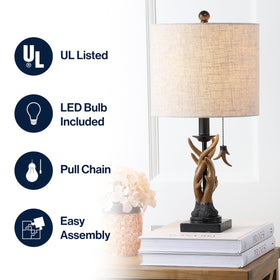 JONATHAN Y resin antlers detail adds a rustic focal point on a nightstand.