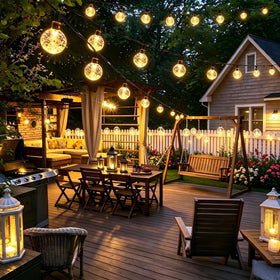 Joomer globe lights decorate wedding venue trees, creating charming outdoor ambiance