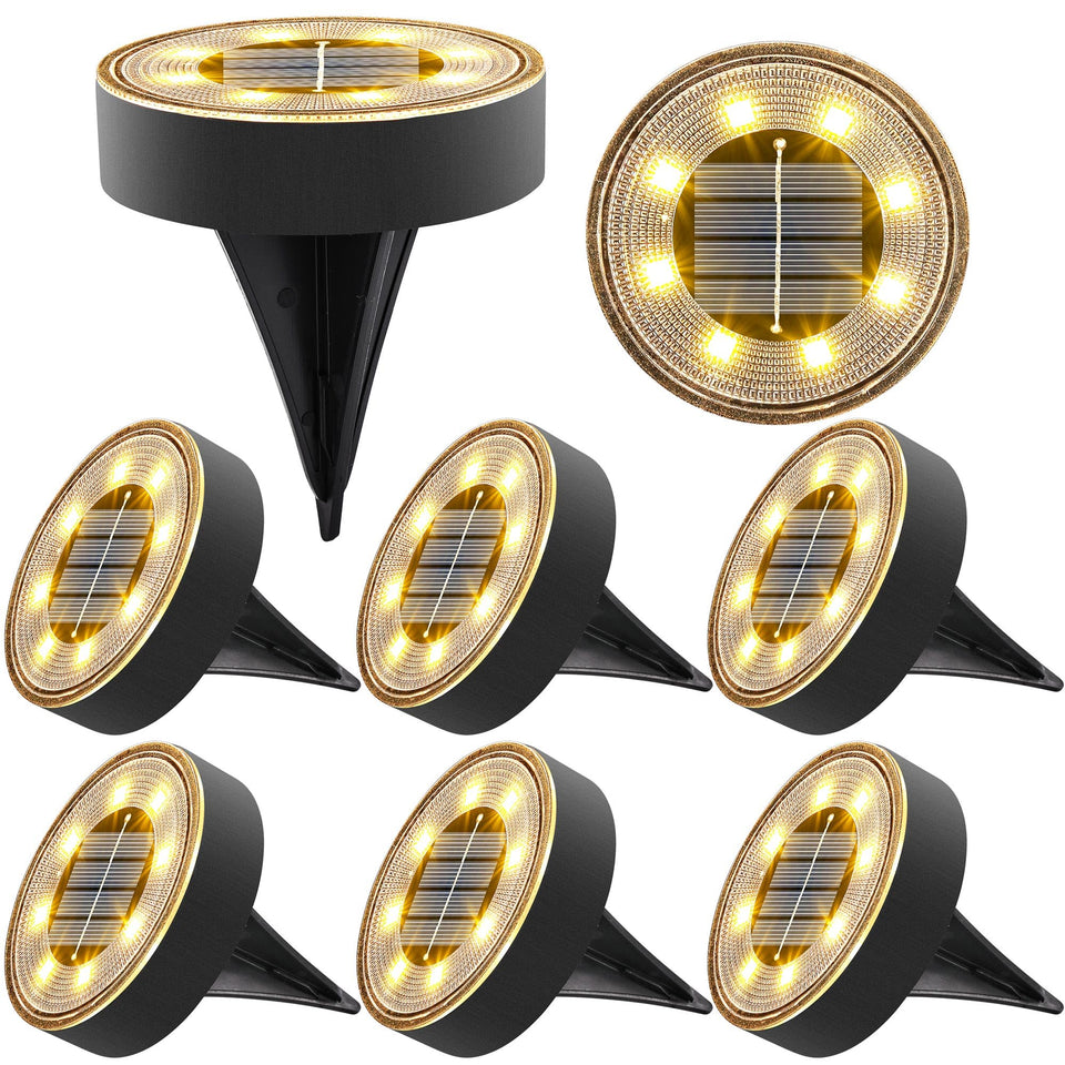 Joomer solar ground light 8-pack illuminating a pathway with warm white glow