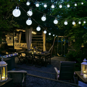 Lights installed along a tree for charming garden decor