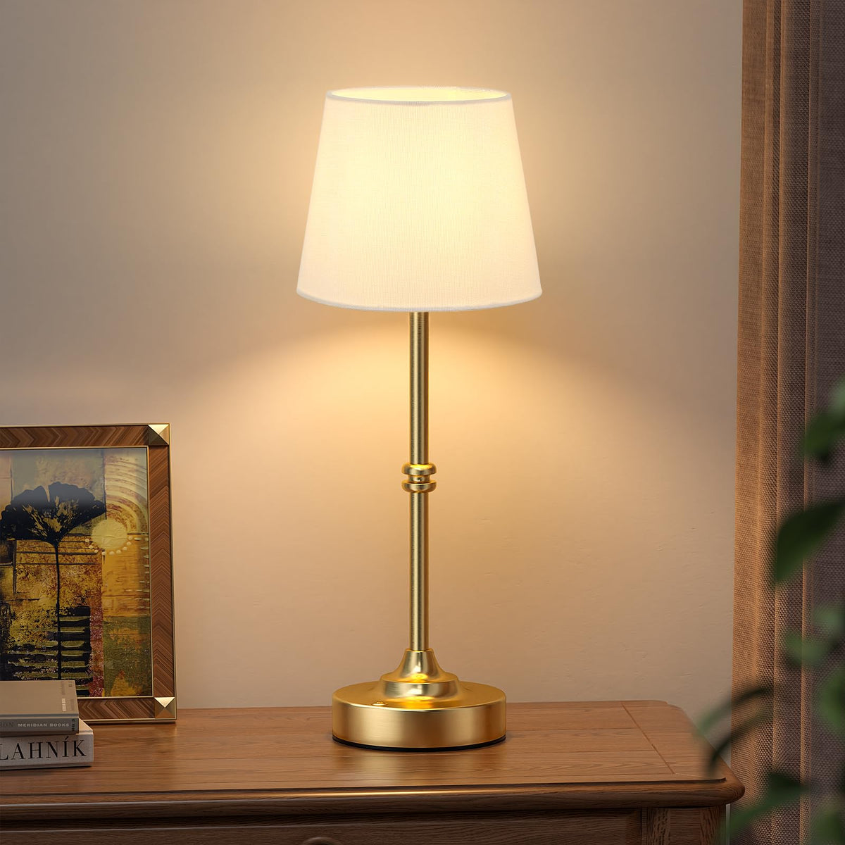 Kakanuo cordless table lamp gold base provides portable illumination for any room.