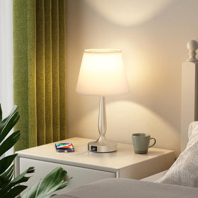 Kakanuo table lamp on bedside table complements nightstand decor.