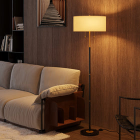 Karjoefar 2-Light Floor Lamp with shade and socket highlights warm, ambient lighting for living spaces.