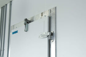 Kason 1094 SureClose installed on a door demonstrates concealed mounting aesthetics and reliability.