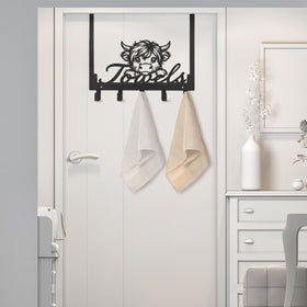 Kathfly Highland Cow hooks in a kitchen setting for towels and utensils.