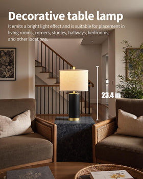 KDG table lamp with beige fabric shade creates warm ambience on a bedroom nightstand.