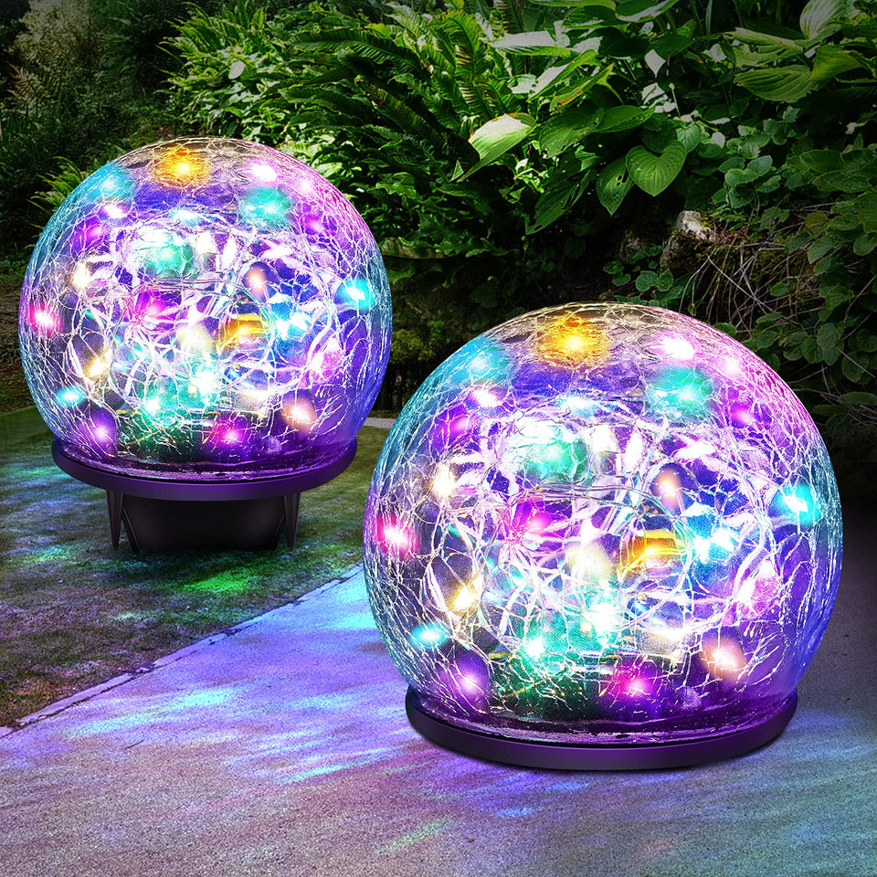 Keevvon two-pack 60 LED solar globe lights brighten garden pathways at night.