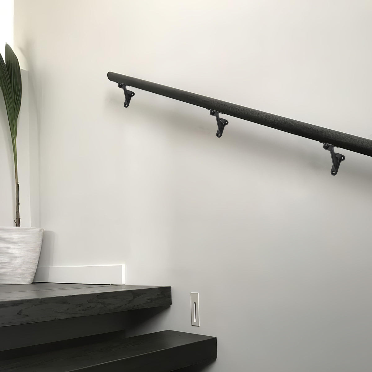 Khtumeware matte black finish bracket highlighting modern decor while supporting handrails.