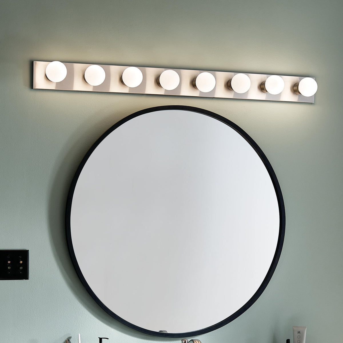 Kichler glass shades detail adding a soft glow to bathroom ambience