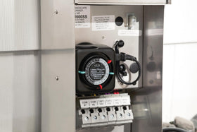 Kichler outdoor timer installed inside a weatherproof enclosure for safe operation.