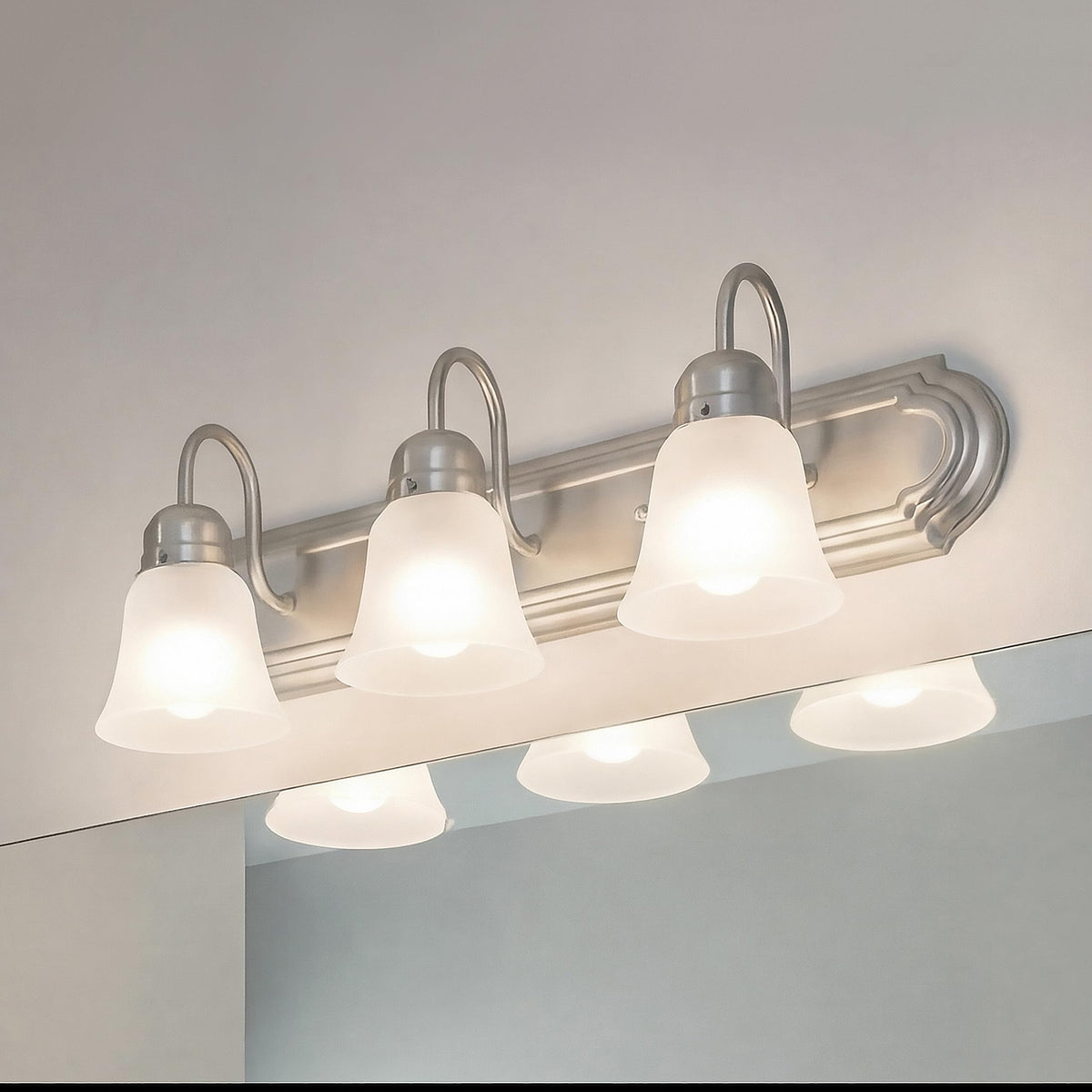 Kichler vanity light 24-inch highlights brushed nickel finish and glass shade.