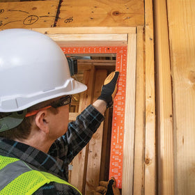 Klein Tools 935FSQ framing square shows built in rafter tables for carpentry calculations.