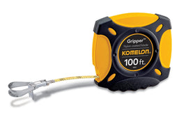 Komelon 9901 closed-case tape in hand, ergonomic grip and durability.