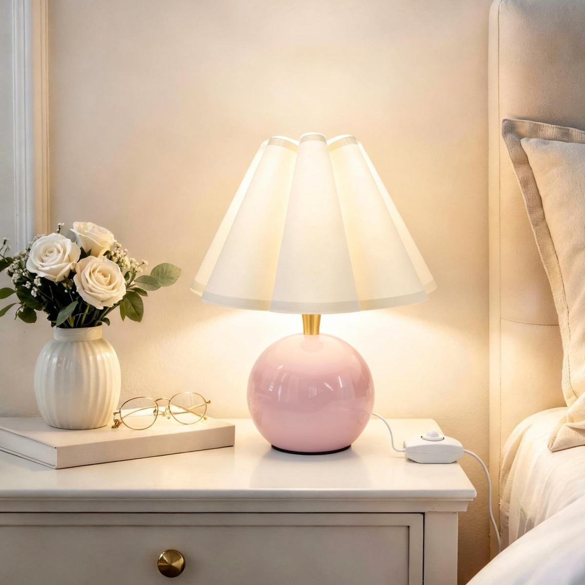 Komothala bedside lamp with ceramic base for a calm, cozy bedside glow.