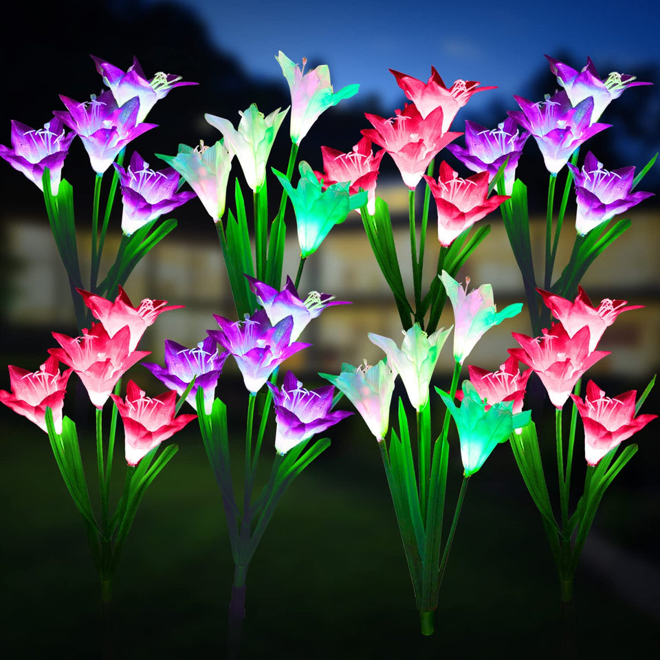 KOOPER outdoor solar lights with bigger lily flowers illuminate garden paths softly.