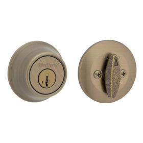 Kwikset 660 antique brass deadbolt on exterior rounded round-front entry door.