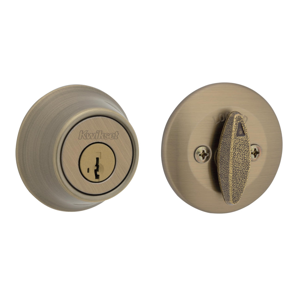 Kwikset 660 antique brass deadbolt on exterior rounded round-front entry door.