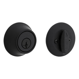 Kwikset 660 matte black deadbolt on a front door for secure entry.