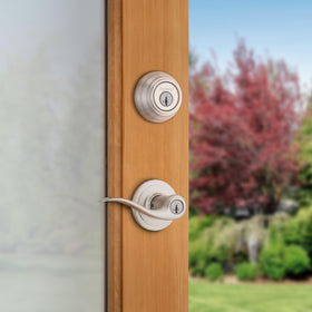 Kwikset 99910-040 Tustin lever and deadbolt on exterior door, satin nickel finish.