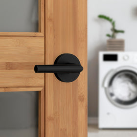 Kwikset Milan matte black lever close-up highlights smooth, wobble-free operation.