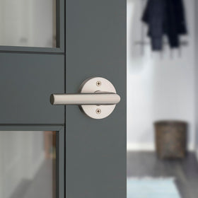 Kwikset Milan satin nickel finish close-up showing modern durable styling