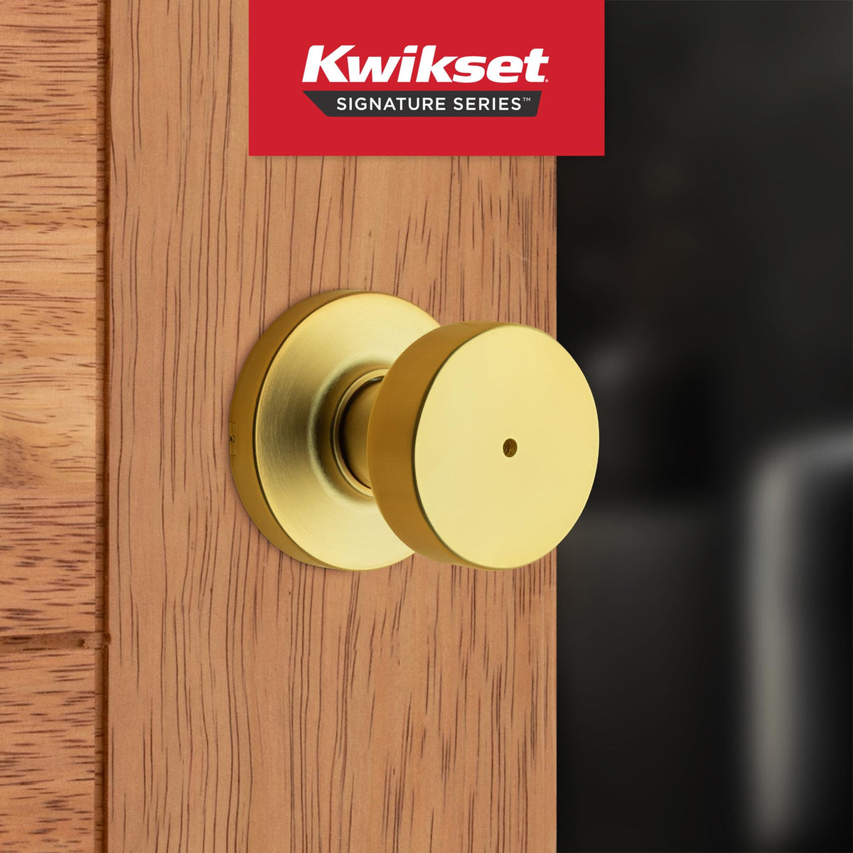 Kwikset Pismo satin brass finish detail highlights contemporary bedroom style.