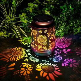 Kyoryuger solar lantern with sunflower pattern casting warm garden light at dusk