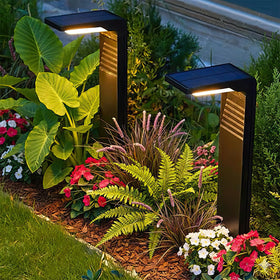 Lampat 6-pack solar pathway lights illuminate dusk glow along a garden path.