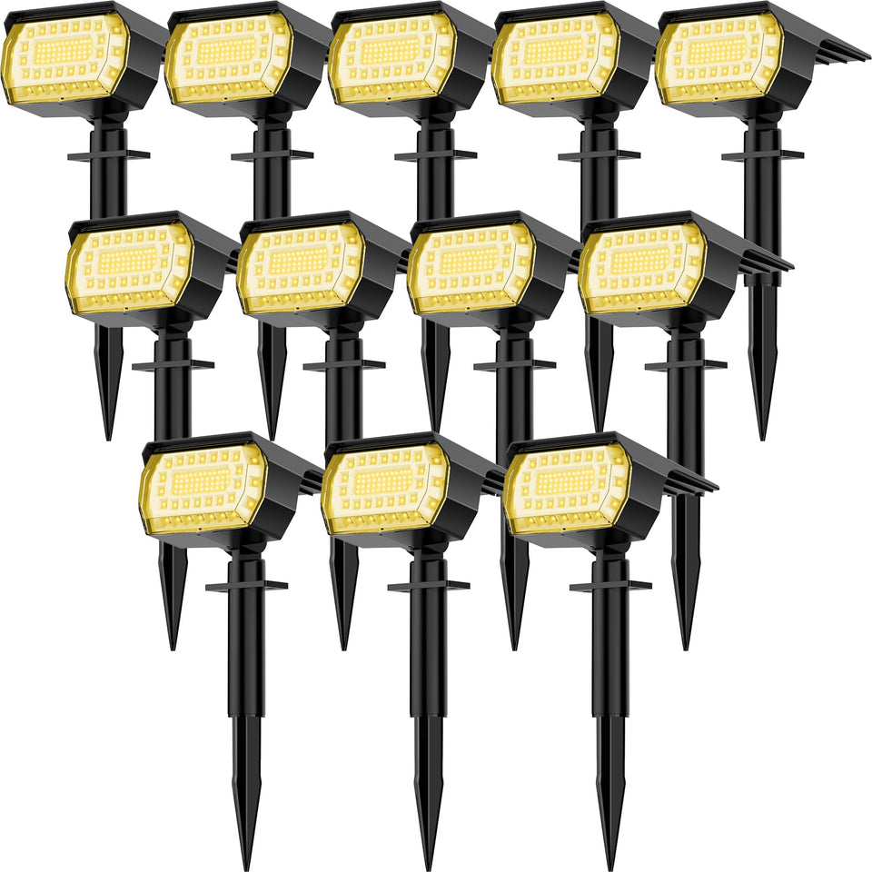 LANSOW solar spot light outdoor 12-pack illuminating a garden pathway