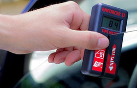Laser Labs Enforcer II Tint Meter in use demonstrates fast, consistent tint measurements for compliance checks.