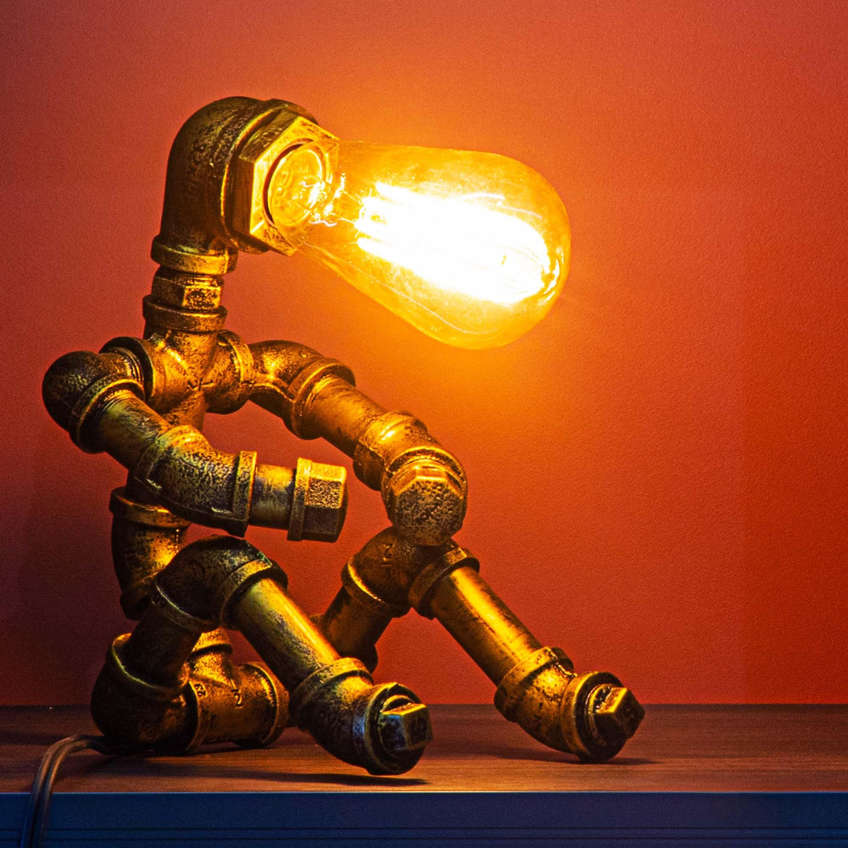 LCYY.TG water-pipe robot lamp on a desk setup for modern home or cafe decor.