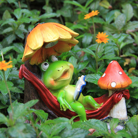 Leekung frog sculpture with mushrooms adds whimsical focal point to garden.