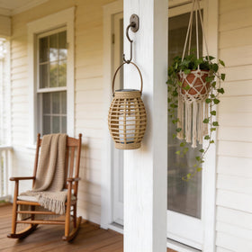 LEOKED garden lantern glows warmly, elevating patio ambiance.