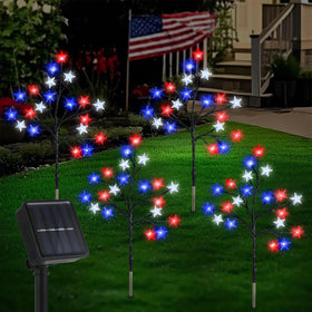 Lewondr 4th of July solar star lights illuminate a garden path with red, blue, and white stars