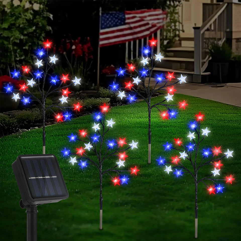 Lewondr 4th of July solar star lights illuminate a garden path with red, blue, and white stars