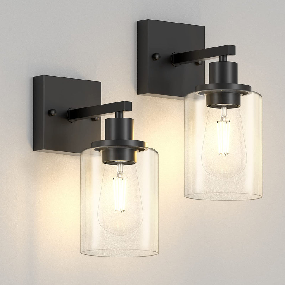 Licperron black vanity sconce with glass shade illuminates bathroom mirror clearly.