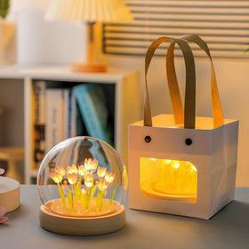 Lifnatty artificial tulips under glass dome enhances elegant decor.