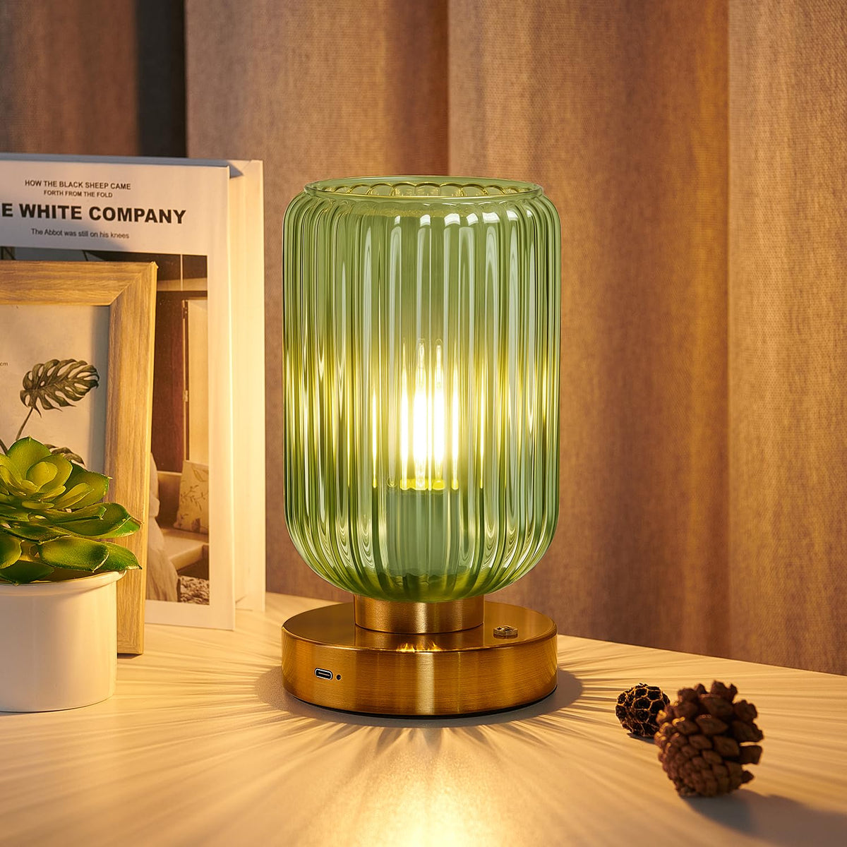 LightRound cordless table lamp with gold base shown in a close-up for bedside lighting.