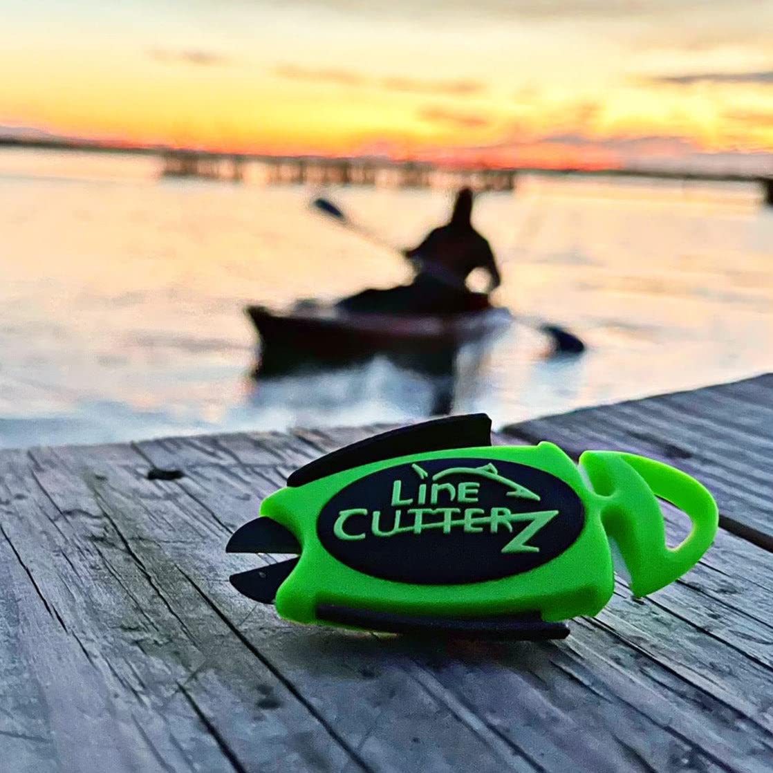 LINE CUTTERZ green clip-on tool attached to belt for quick access on deck