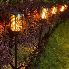 Liveasily LED torch lights illuminating a garden for cozy evenings.