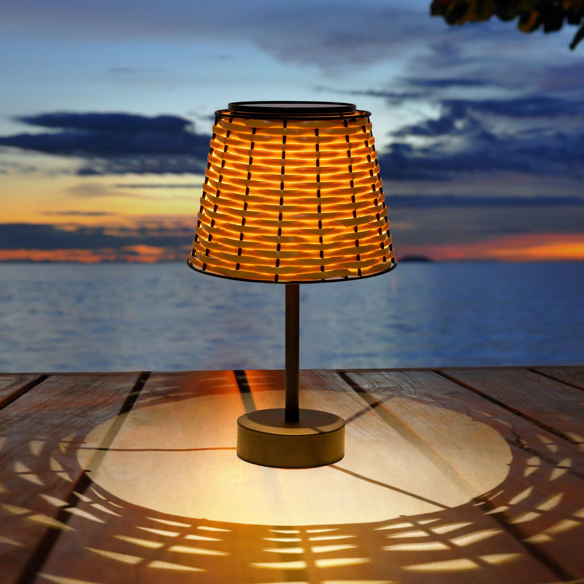 Livinlarge solar table lamp outdoors with rattan shade provides warm ambient light for evenings