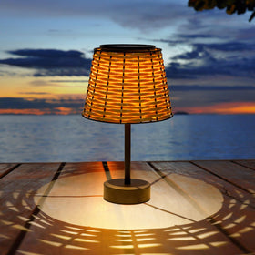 Livinlarge solar table lamp outdoors with rattan shade provides warm ambient light for evenings